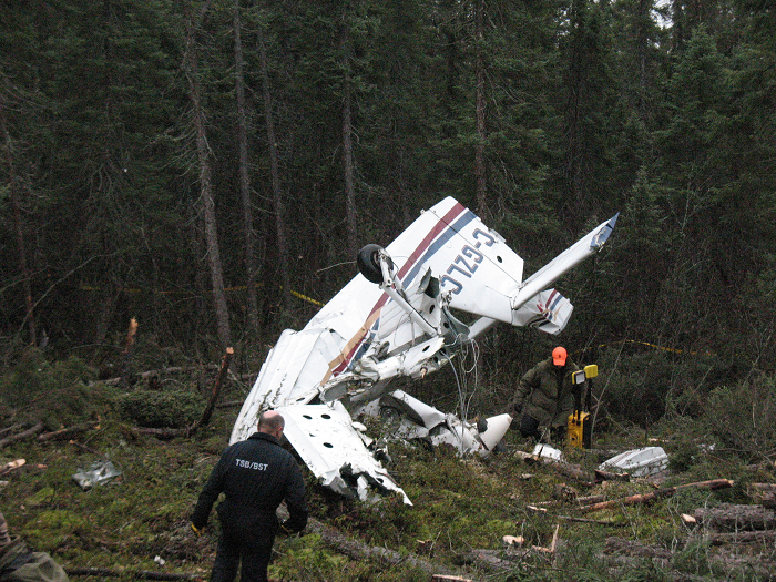 Allen Barrett, TSB Central Region investigator, and a member of the Ontario Provincial Police emergency response team on the site of the accident