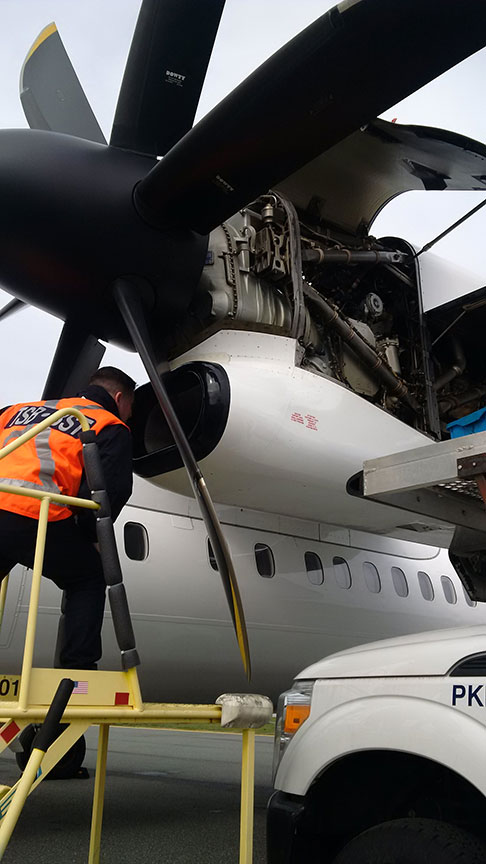 TSB investigator examining one of the engines of the occurrence aircraft