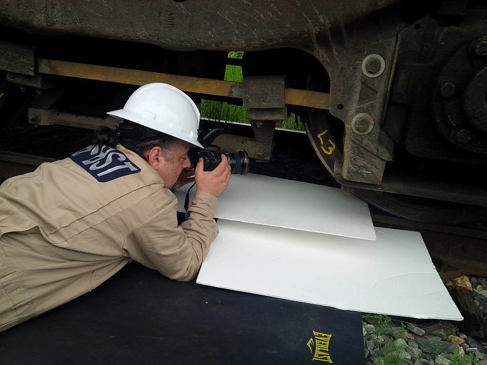 Tony Gasbarro, Multimedia Investigation Specialist, documents a wheel set on a locomotive in Lac-Mégantic