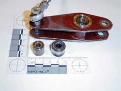Photo of Bellcrank assembly with a part number 5453032-1 roller on the left and a YCRS-12 bearing on the right
