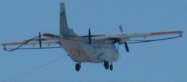 Photo of C-FDKM in flight with birds deployed