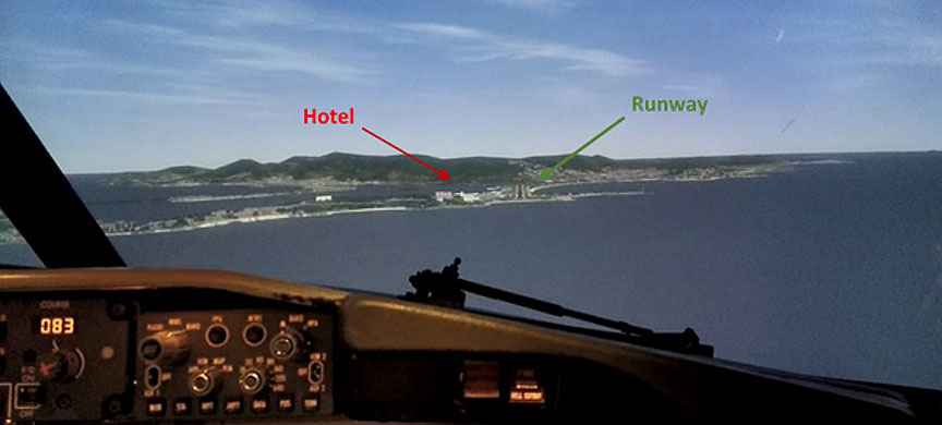 Approach to Runway 10 at TNCM on a clear day, viewed in a flight simulator