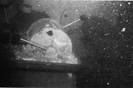 Starboard wheel-house engine and propeller pitch controls photographed underwater before refloating. 