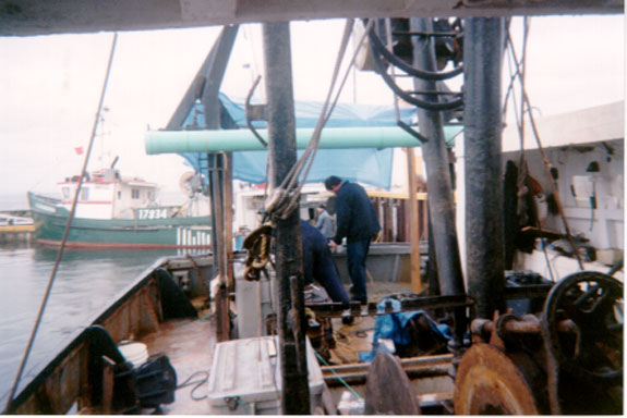 View of the after deck during repairs to the crane - hatch coaming - panels removed