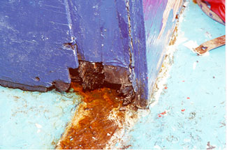 Photo of the disintegration due to dry rot of inboard base of bridge front door frame (outboard base similar)