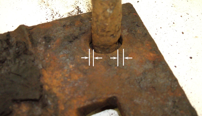 Photo of the spike hole of the tie plate indicating the hole is enlarged by up to a quarter inch