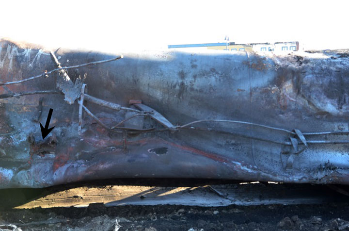 Image of Tank car ACFX 71121, burn-throughs and puncture, as decribed in text