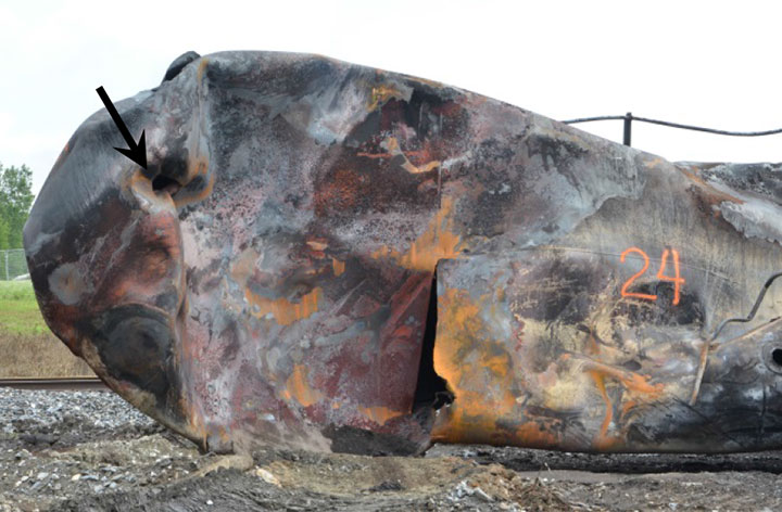 Image of Tank car ACFX 76605, detail of large shell rupture, as decribed in text