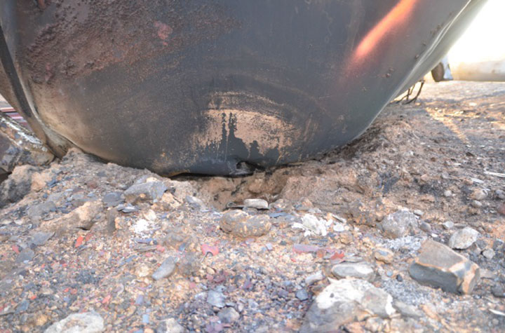 Image of Tank car DBUX 303879, photo showing small puncture, as decribed in text