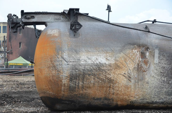 Image of Tank car NATX 310457, close-up showing dent, as decribed in text