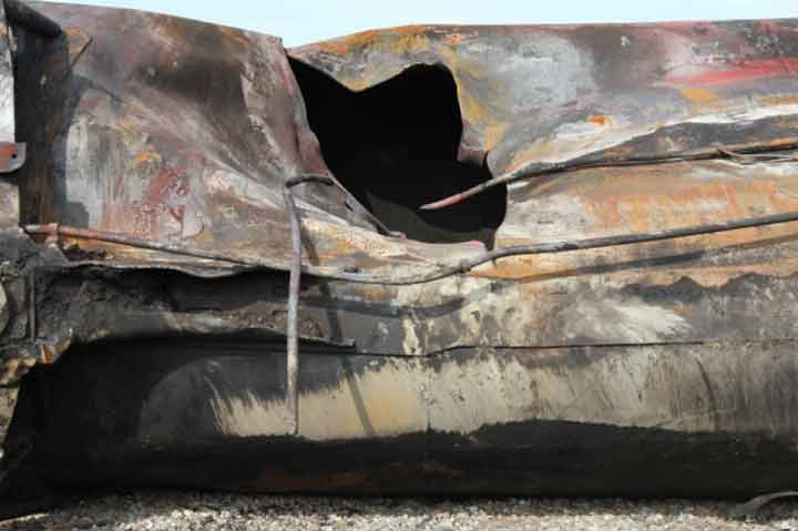 Image of Tank car PROX 44202, close-up of large puncture, as decribed in text