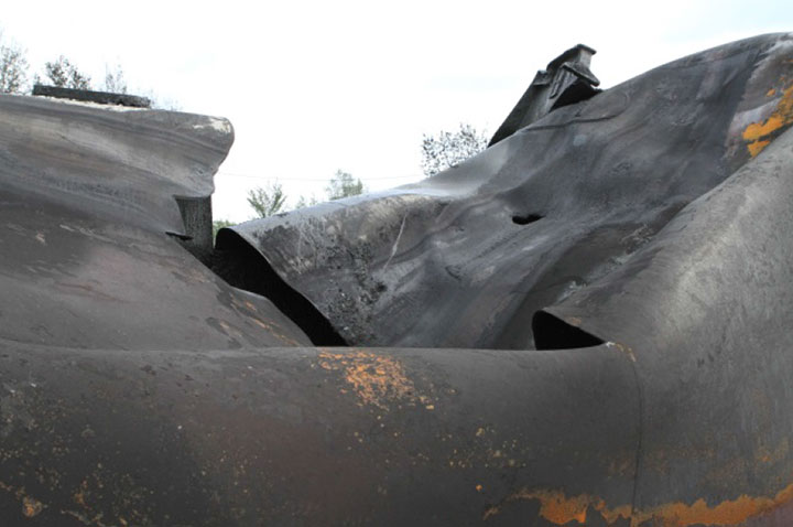 Image of Tank car TILX 316330, shell puncture and rupture, as decribed in text