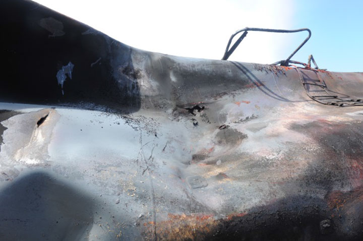 Image of Tank car WFIX 130545, close up puncture and burn-through, as decribed in text