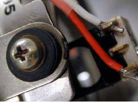 Non-SR 111 exhibit with signs of a short circuit on the frame of the socket rivet assembly