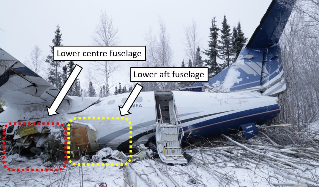 Left side view of the lower centre and aft fuselage sections of the aircraft at the crash site (Source: TSB)