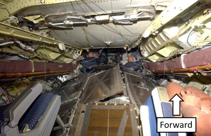 Photo of reduced habitable (survivable) space in centre cabin as a result of collapsed wing and intrusion of main landing gear structure during 2006 drop test (Source: U.S. Federal Aviation Administration, with TSB annotations)