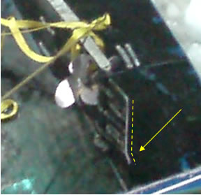 Photo 4. Close-up view of the overturned vessel, showing rudder