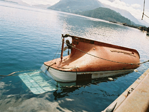 Capsized 12.65 m prawn-fishing vessel Morning Sunrise tied alongside a dock