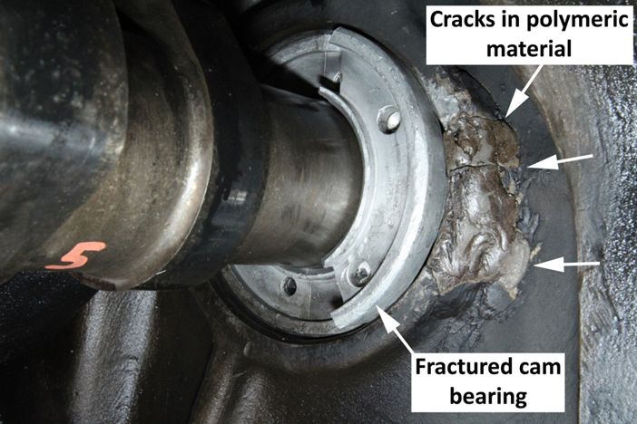 Photo of the polymeric material applied to cam bearing bore and fractured cam bearing