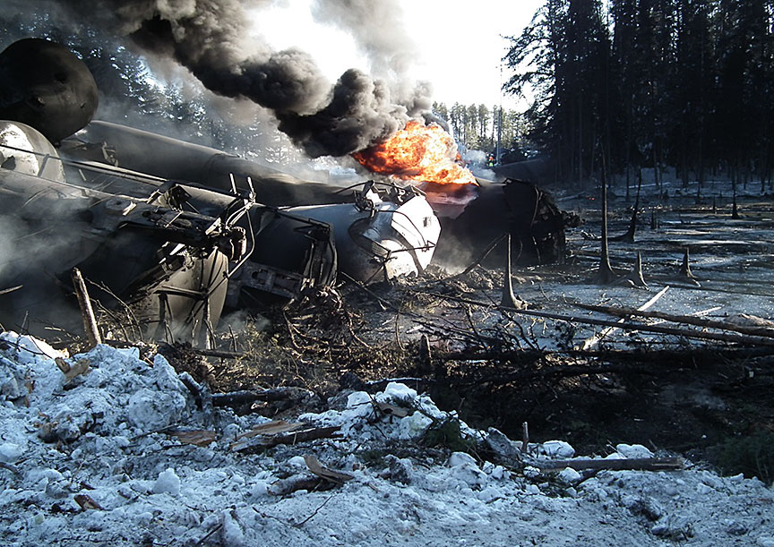 Derailment site with tank car burning from thermal tear