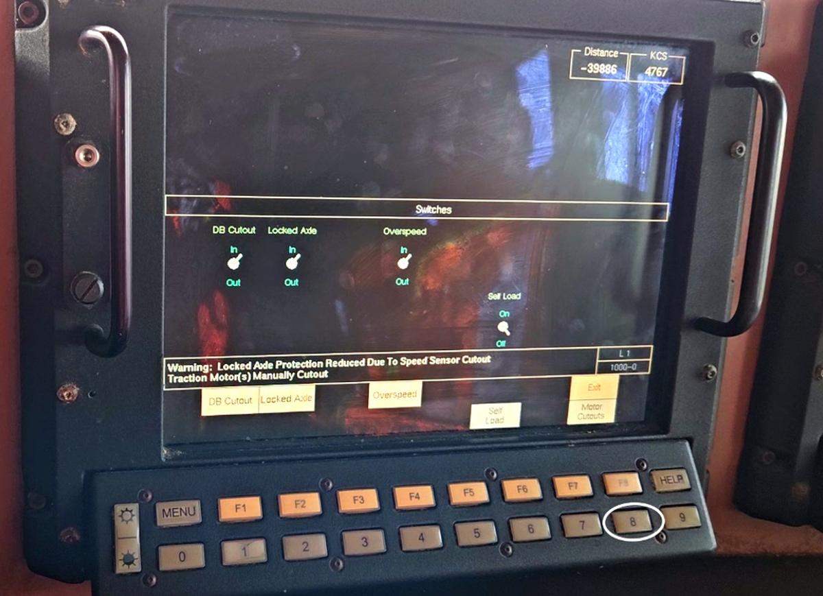  Figure 6. Control monitor and keyboard on locomotives in the ES44AC series; the monitor is displaying the “Switches” screen, and a circle shows the location of the 8 hard key