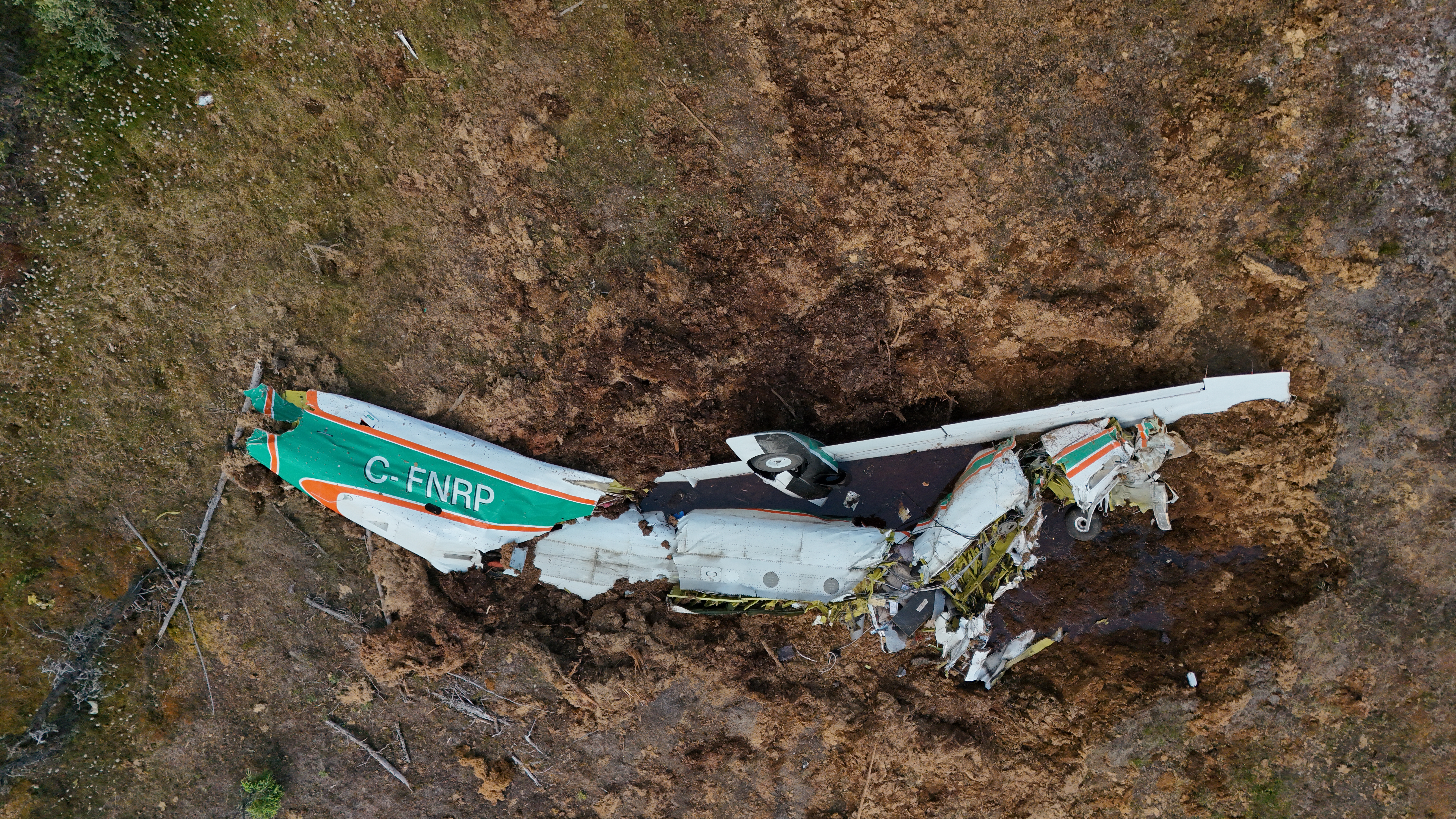 Photo 2: Close-up aerial view of the wreckage following the 24 June 2026 in-flight breakup and collision with terrain near Fort Simpson Airport, Northwest Territories (Source: Transportation Safety Board of Canada)