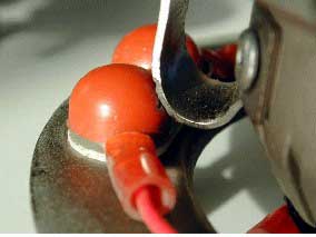 Non-SR 111 exhibit with signs of arcing on the bracket and on the orange insulating cap